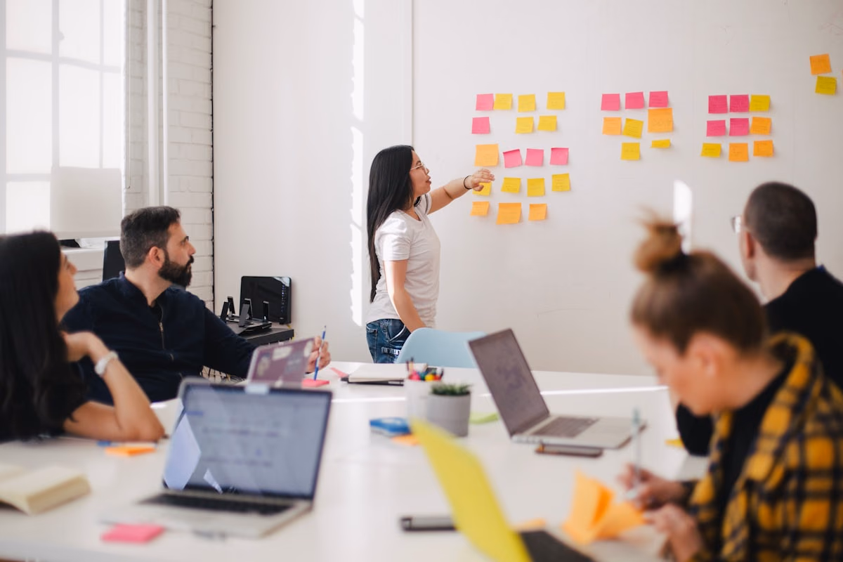 Consulting team reviewing ideas around a conference table.